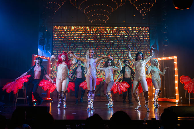 A candid shot of the queens on stage.