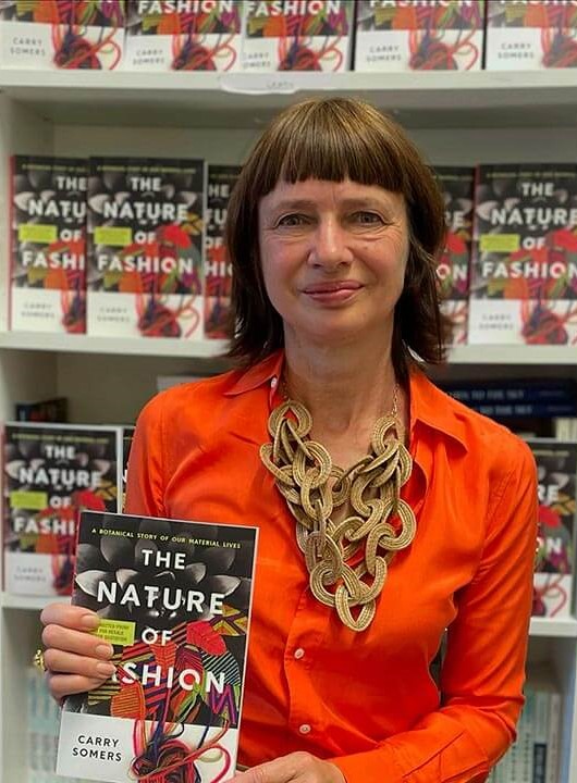 Carry Somers poses with her book The Nature of Fashion