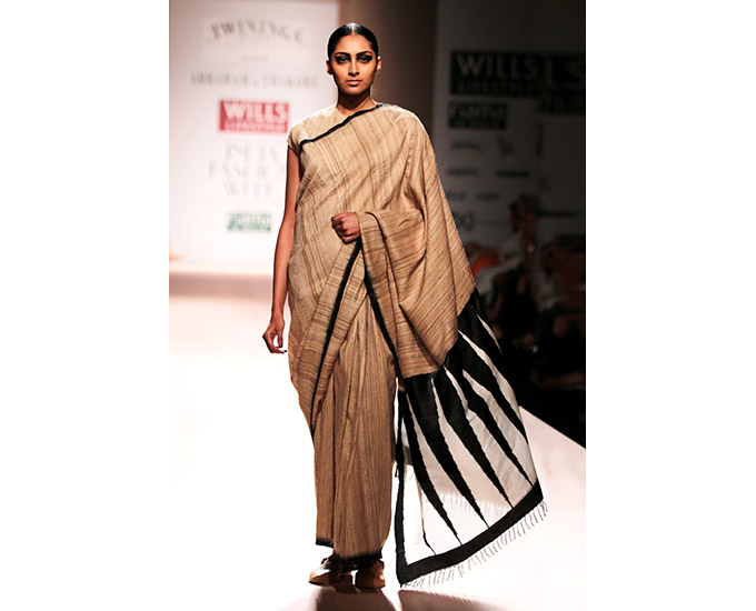A handwoven tussar silk sari with temple motifs on jamdani inlay by Abraham & Thakore.Abraham & Thakore