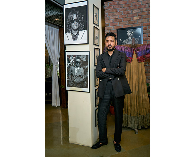 Tasnim at his Noida atelier, in the quiet company of photographs of the late Rohit Bahl.